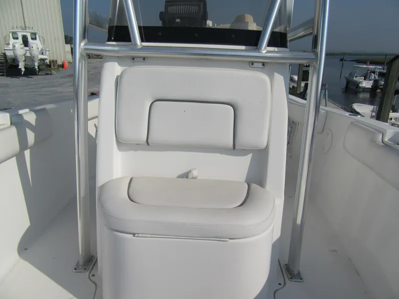 Slide: The Image of 2014 Sea Hunt Ultra 234 boat seat with white cushioned backrest and stainless steel frame. - 5