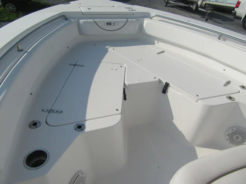 Slide: The Image of 2014 Sea Hunt Ultra 234 boat interior with storage compartments and seating area. - 7