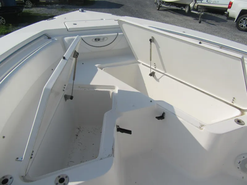 Slide: The Image of 2014 Sea Hunt Ultra 234 boat with open storage compartments. - 8