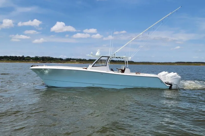 Slide: The Image of 2024 Front Runner 37 Catamaran on calm water under blue sky. - 10