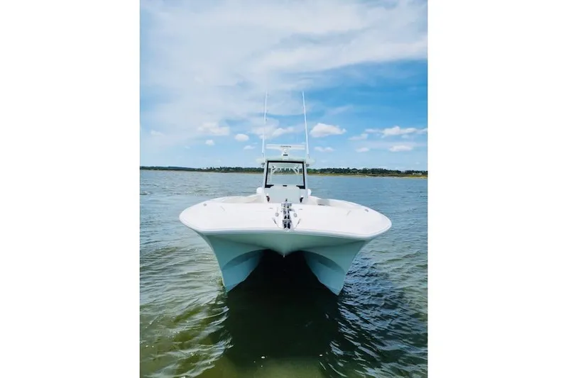 Slide: The Image of 2024 Front Runner 37 Catamaran docked by a serene riverbank. - 11