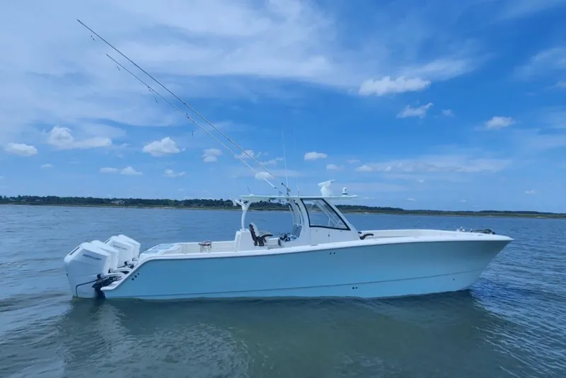 Slide: The Image of 2024 Front Runner 37 Catamaran on calm water under a clear blue sky. - 2