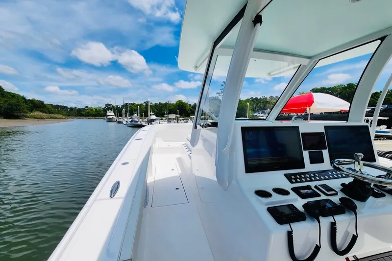 Slide: The Image of 2024 Front Runner 37 Catamaran, sleek design, advanced navigation, docked in a scenic marina. - 6