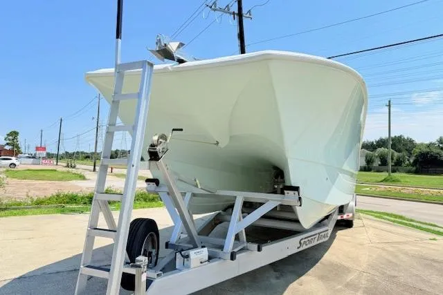 Slide: The Image of 2024 Front Runner 37 Catamaran on trailer, parked outdoors under clear blue sky. - 8