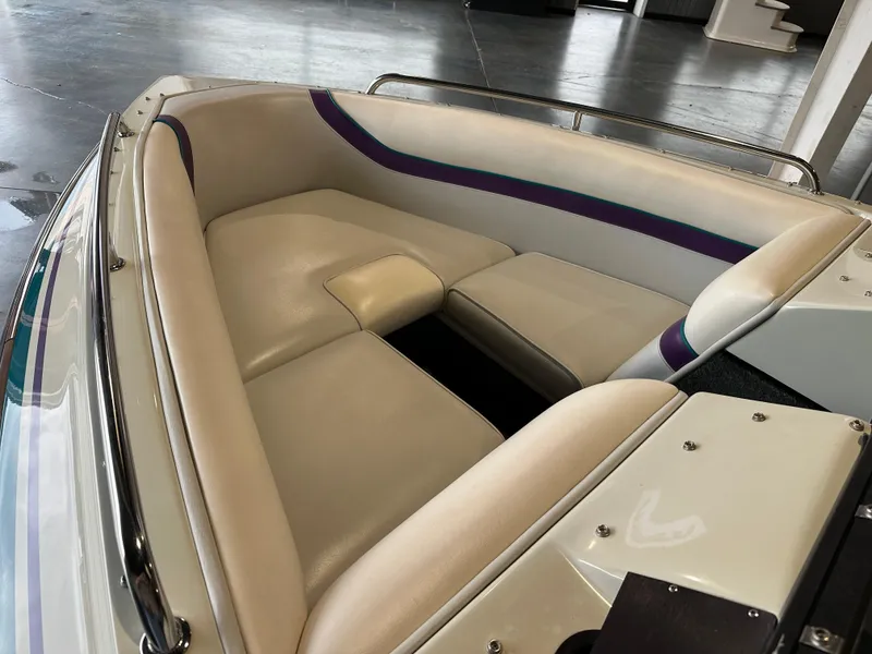 Slide: The Image of 1995 Tigé 2002 FSLM COMP boat interior with cream and purple seating. - 7