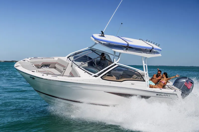 The Image of 2026 Solara S-250 DC boat cruising on clear blue water with passengers enjoying the ride. - 0