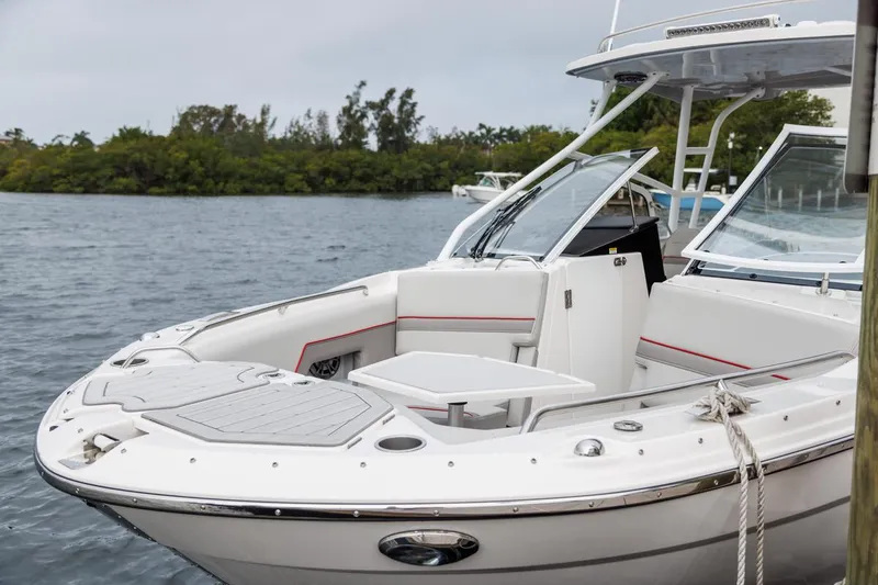 Slide: The Image of 2026 Solara S-250 DC boat docked on a calm lake with lush greenery. - 16