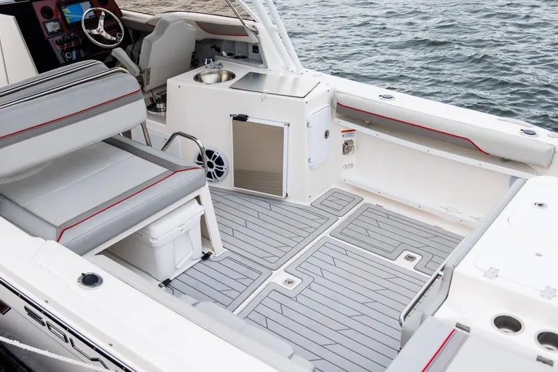 Slide: The Image of 2026 Solara S-250 DC boat interior with sleek seating and modern amenities by the water. - 17