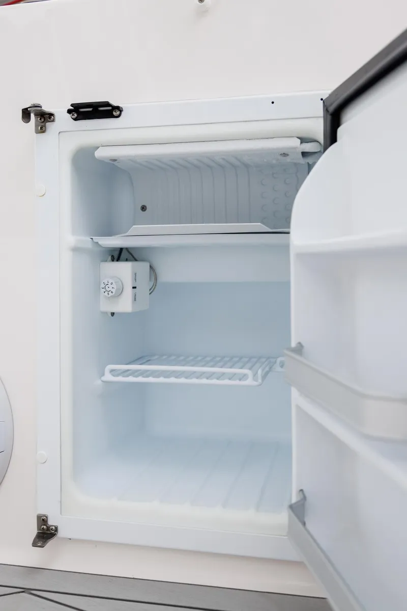 Slide: The Image of 2026 Solara S-250 DC refrigerator interior with open door, showcasing shelves and cooling unit. - 19