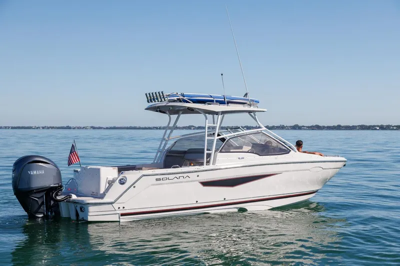 Slide: The Image of 2026 Solara S-250 DC boat on calm water, featuring a Yamaha outboard motor. - 5