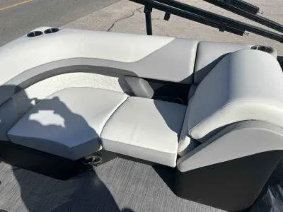 Slide: The Image of 2025 Lowe SS 230 boat seating with gray and white upholstery, featuring cup holders. - 10
