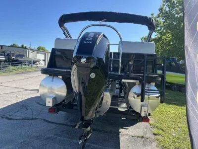 Slide: The Image of 2025 Lowe SS 230 pontoon boat with powerful outboard motor, parked outdoors. - 3