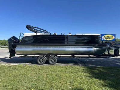 Slide: The Image of 2025 Lowe SS 230 pontoon boat on trailer under clear blue sky. - 6