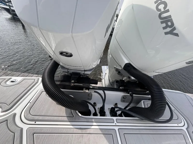 Slide: The Image of 2024 Blackfin 302DC boat with dual Mercury outboard engines on water. - 20