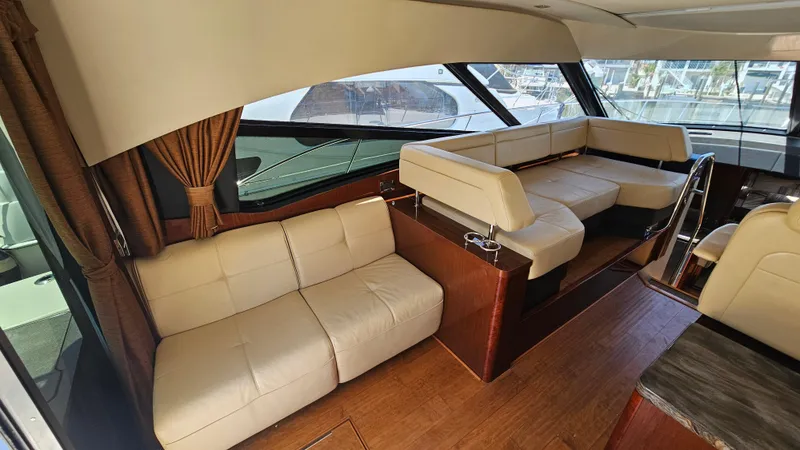Slide: The Image of Interior of 2016 Sea Ray 470 Sundancer yacht with beige leather seating and wooden flooring. - 15