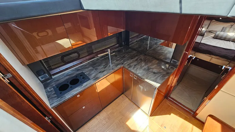 Slide: The Image of Luxurious kitchen interior of 2016 Sea Ray 470 Sundancer yacht with modern amenities. - 18