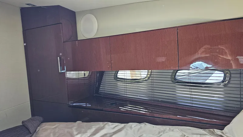 Slide: The Image of Interior cabin of 2016 Sea Ray 470 Sundancer yacht with wood cabinetry and windows. - 22