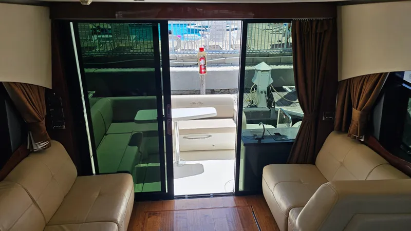 Slide: The Image of Interior view of 2016 Sea Ray 470 Sundancer yacht with leather seating and glass doors. - 28