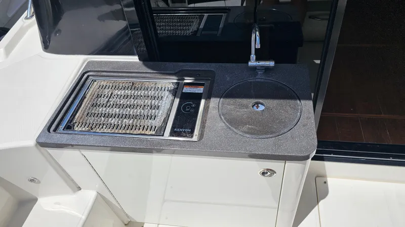Slide: The Image of Outdoor kitchenette on 2016 Sea Ray 470 Sundancer yacht with grill and sink. - 31