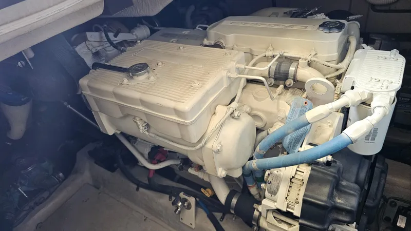 Slide: The Image of Engine compartment of a 2016 Sea Ray 470 Sundancer boat, showcasing mechanical components. - 33
