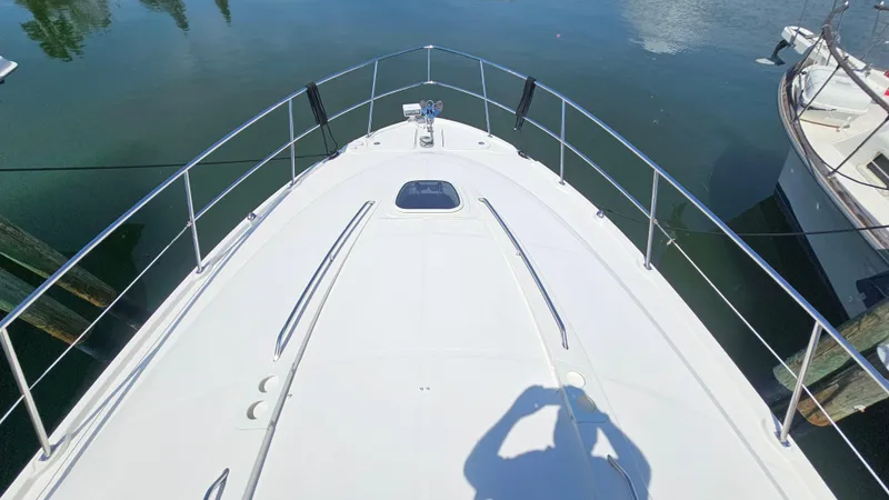 Slide: The Image of Bow view of 2016 Sea Ray 470 Sundancer yacht on calm water. - 37