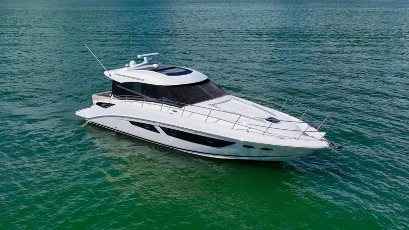 Slide: The Image of 2016 Sea Ray 470 Sundancer yacht cruising on clear blue water. - 7