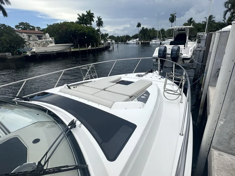 Slide: The Image of 2022 Boston Whaler 405 Conquest docked in a scenic marina setting. - 3