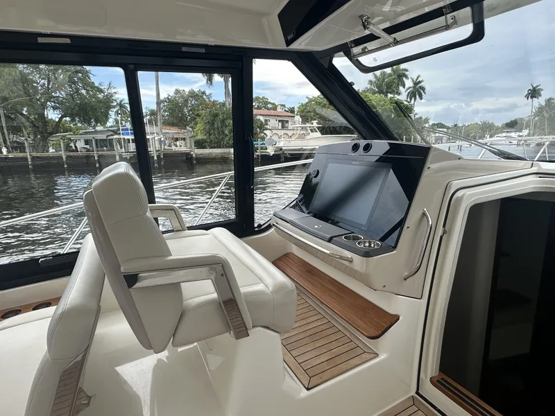 Slide: The Image of 2022 Boston Whaler 405 Conquest helm with modern controls and waterfront view. - 5