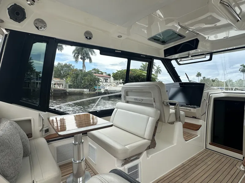 Slide: The Image of Interior of 2022 Boston Whaler 405 Conquest boat with luxurious seating and waterfront view. - 6