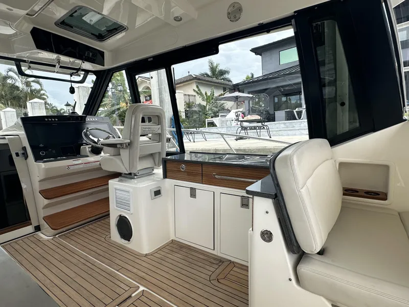 Slide: The Image of 2022 Boston Whaler 405 Conquest interior with modern helm and seating area. - 7