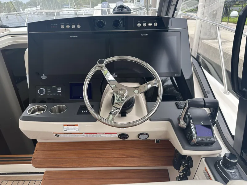 Slide: The Image of Helm of 2022 Boston Whaler 405 Conquest with modern controls and navigation screens. - 8