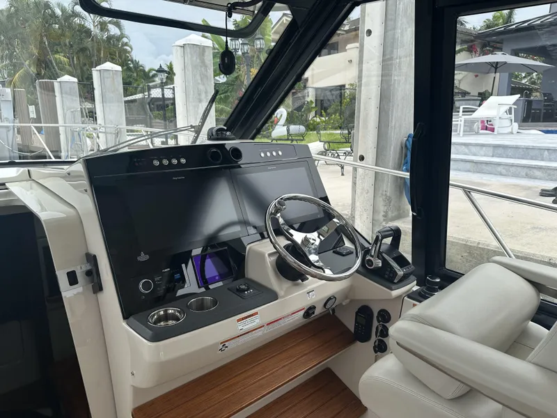 Slide: The Image of Helm of 2022 Boston Whaler 405 Conquest with modern controls and steering wheel. - 9