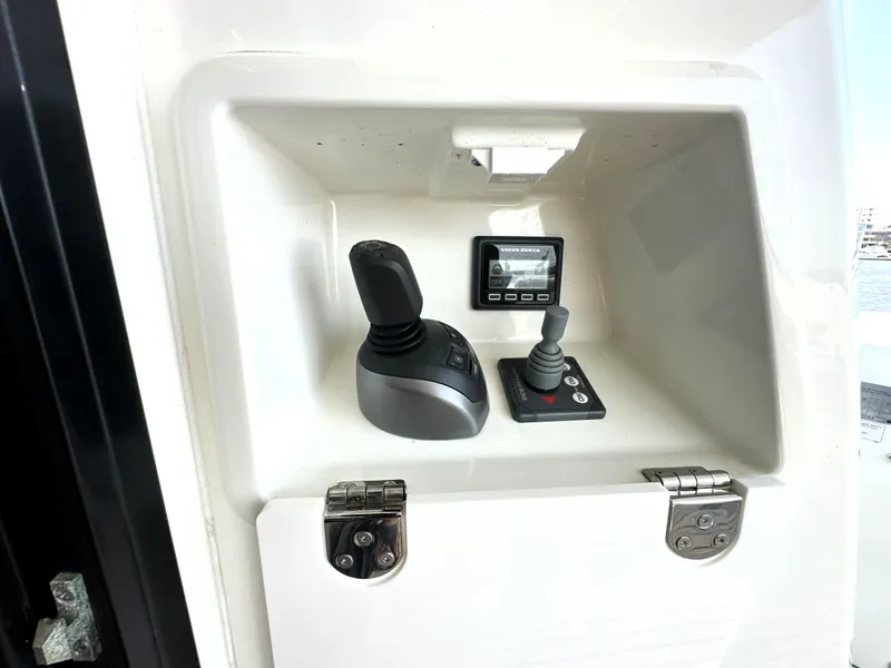Slide: The Image of Control panel of a 2022 Prestige 520 yacht with joysticks and display. - 11