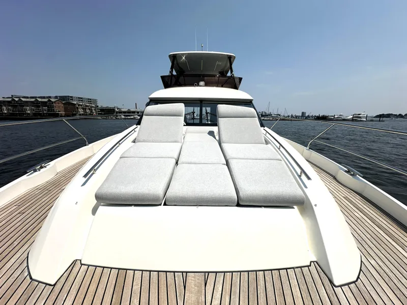 Slide: The Image of 2022 Prestige 520 yacht with sun loungers on deck, docked in a marina. - 14