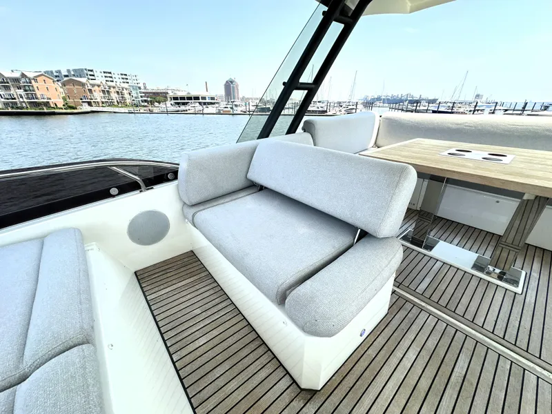 Slide: The Image of Luxurious 2022 Prestige 520 yacht with elegant seating and scenic marina view. - 17