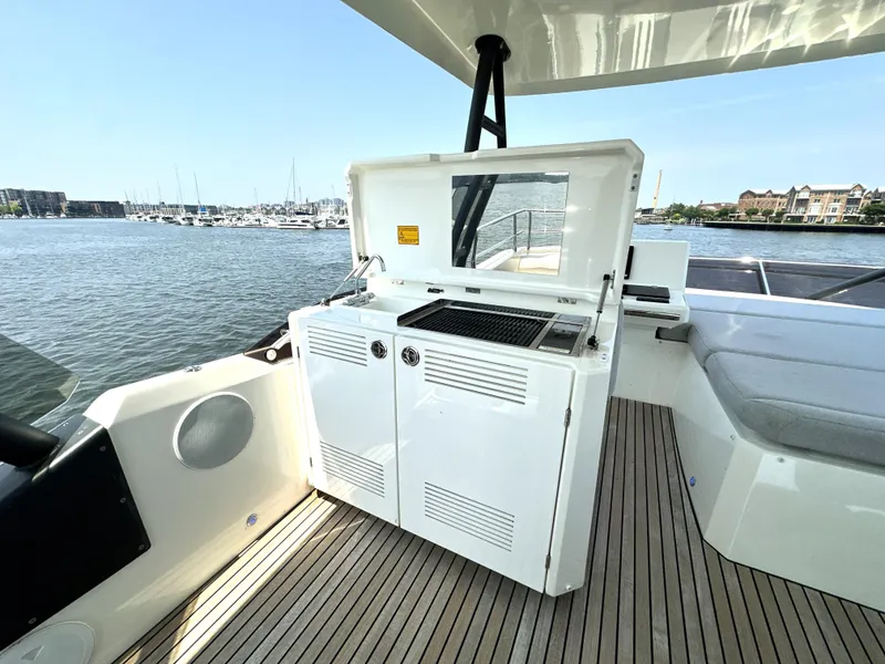 Slide: The Image of Prestige 520 yacht deck with outdoor kitchen, 2022 model, overlooking marina. - 18