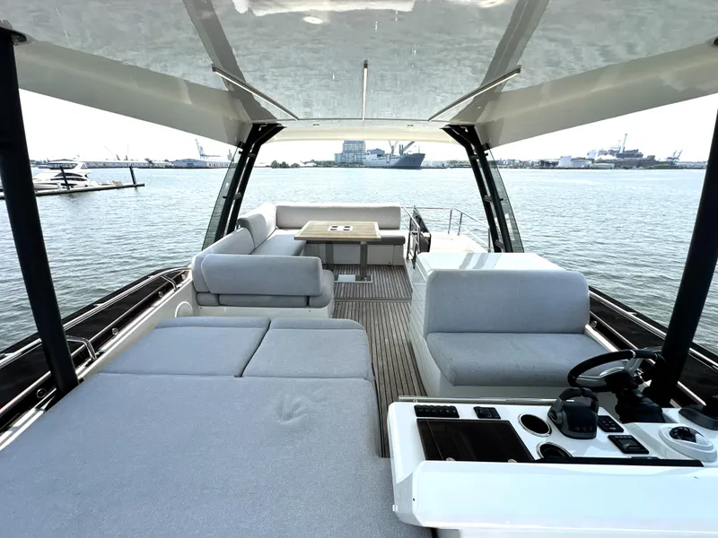 Slide: The Image of Luxurious 2022 Prestige 520 yacht interior with spacious seating and scenic water view. - 19