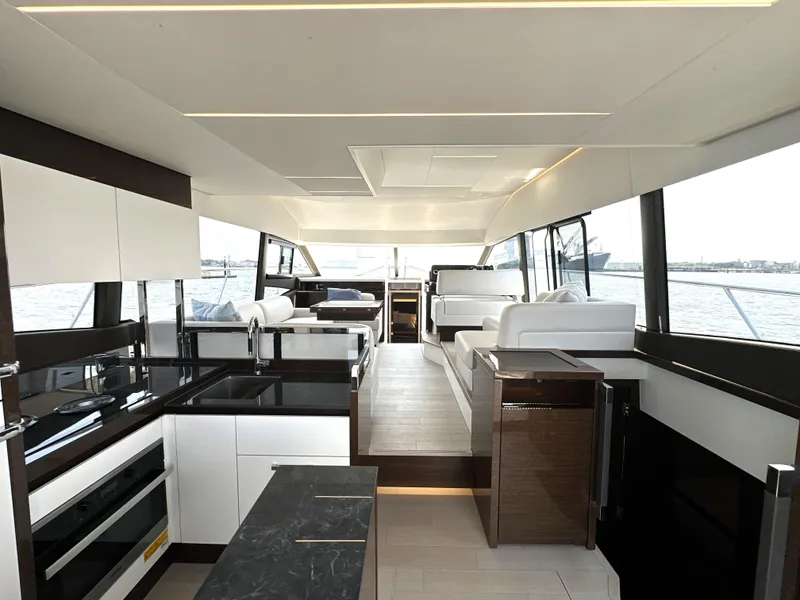 Slide: The Image of Luxurious interior of a 2022 Prestige 520 yacht with modern kitchen and seating area. - 26
