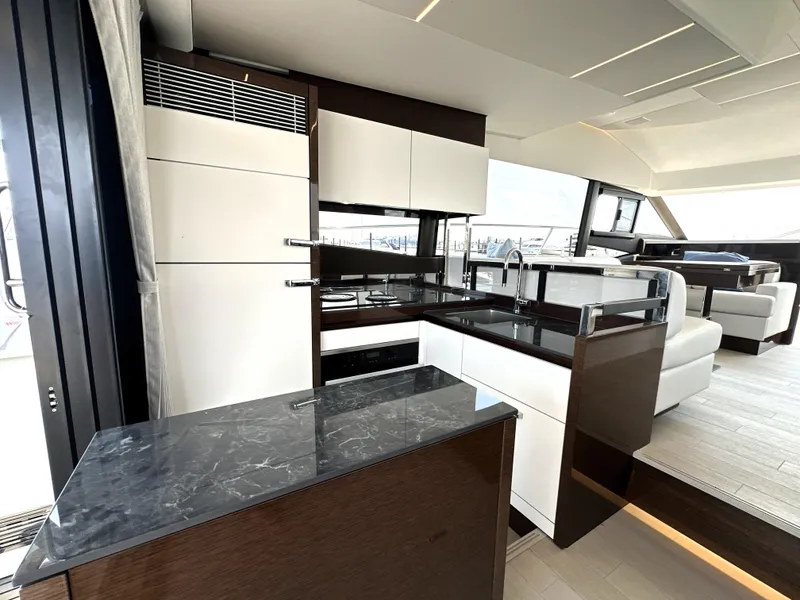Slide: The Image of Luxurious interior of 2022 Prestige 520 yacht with modern kitchen and seating area. - 27