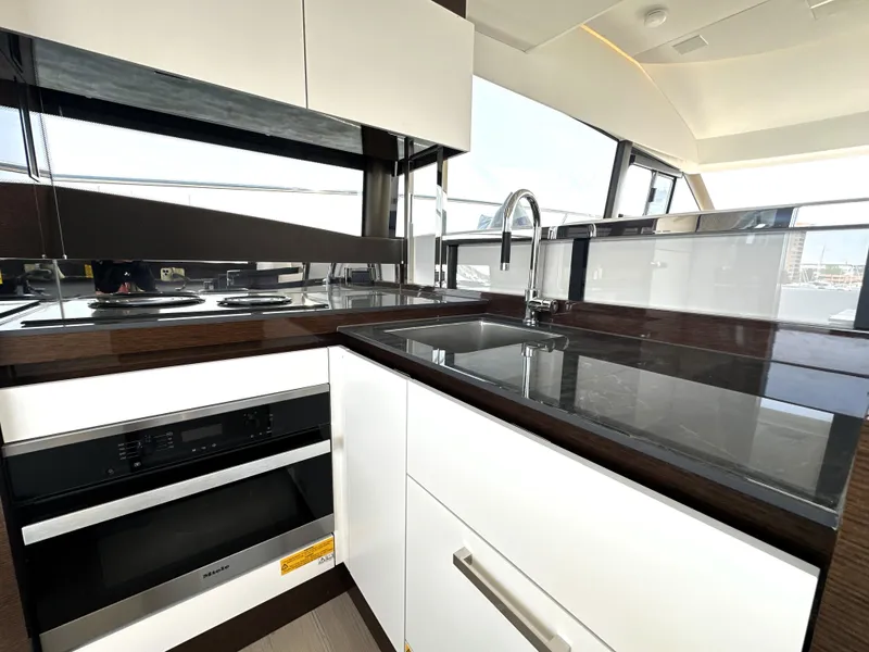 Slide: The Image of Modern kitchen interior on 2022 Prestige 520 yacht with sleek countertops and appliances. - 28