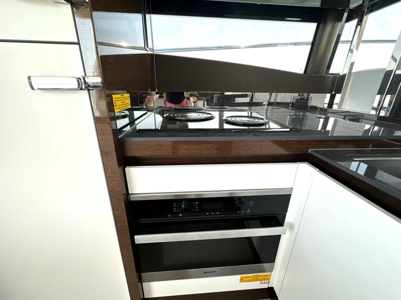 Slide: The Image of Modern kitchen in 2022 Prestige 520 yacht with sleek appliances and glossy finishes. - 29