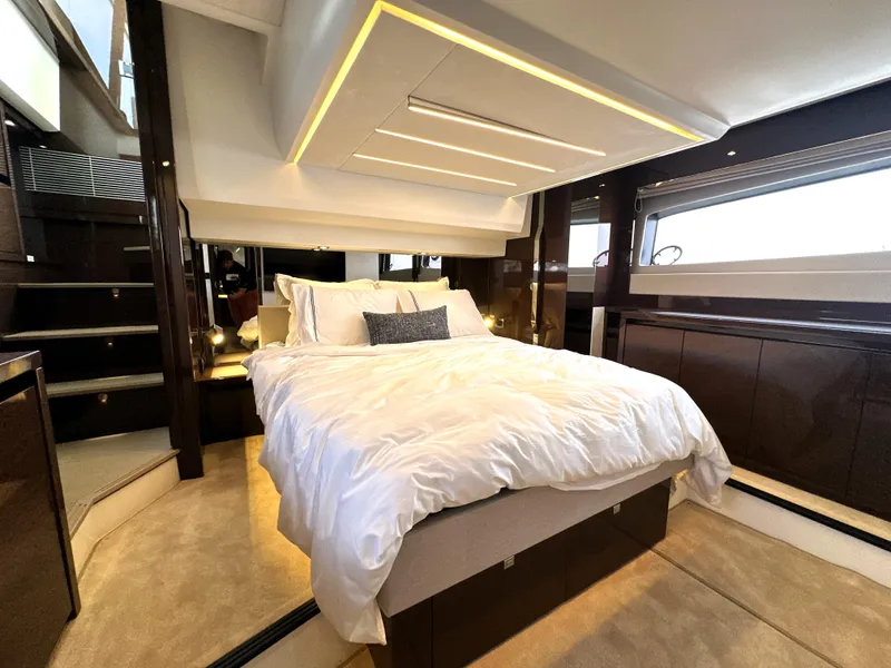 Slide: The Image of Luxurious bedroom interior of 2022 Prestige 520 yacht with modern design and cozy bedding. - 3