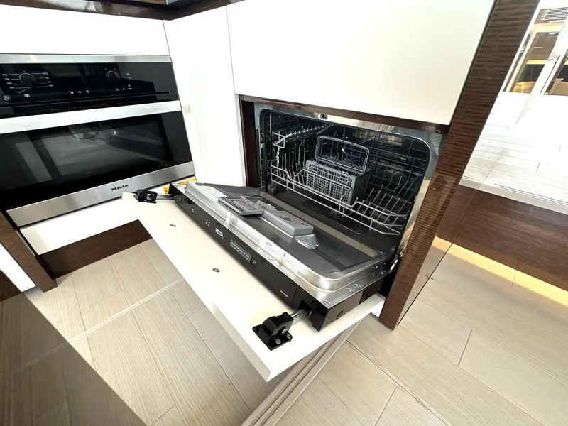 Slide: The Image of Modern kitchen with open dishwasher in a 2022 Prestige 520 yacht. - 30