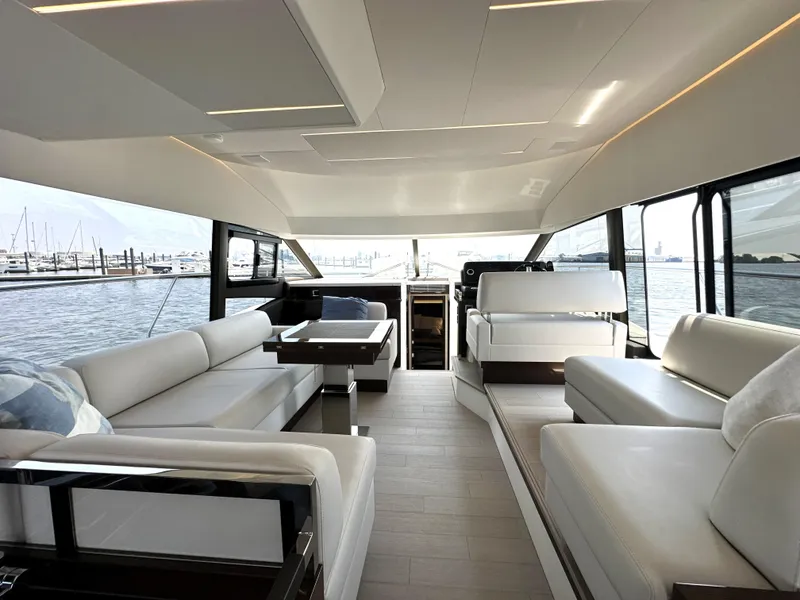 Slide: The Image of Luxurious interior of a 2022 Prestige 520 yacht with elegant seating and panoramic windows. - 31