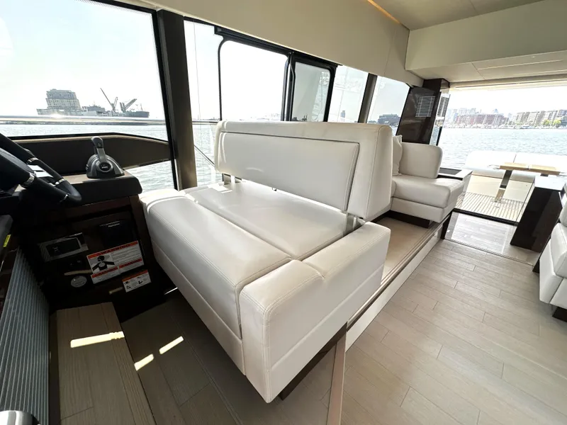 Slide: The Image of Luxurious interior of 2022 Prestige 520 yacht with white leather seating and panoramic windows. - 36