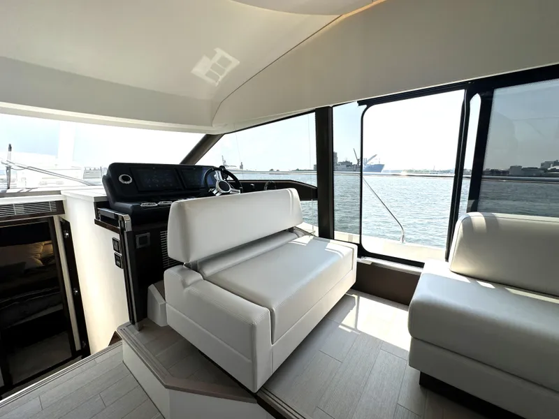 Slide: The Image of Luxurious interior of 2022 Prestige 520 yacht with modern seating and panoramic windows. - 37