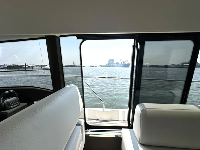 Slide: The Image of Interior view from a 2022 Prestige 520 yacht, overlooking a serene waterfront. - 39