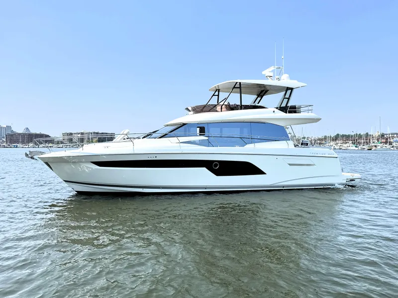 Slide: The Image of Luxury 2022 Prestige 520 yacht on calm water, showcasing sleek design and modern features. - 4