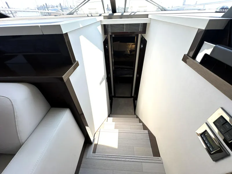 Slide: The Image of Staircase leading to lower deck of 2022 Prestige 520 yacht interior. - 41