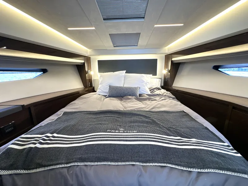 Slide: The Image of Luxurious bedroom interior of 2022 Prestige 520 yacht with elegant bedding and ambient lighting. - 42